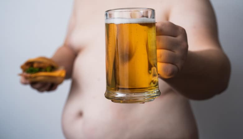 Beer belly shows overweight man. Large Beer belly shows excess weight. Beer belly signals abdominal obesity. Unhealthy Beer belly shows visceral fat.