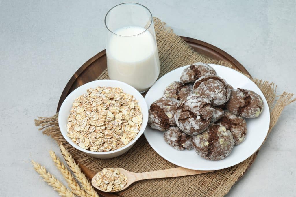 Organic oatmeal, oat milk, vegan product concept. on wooden background